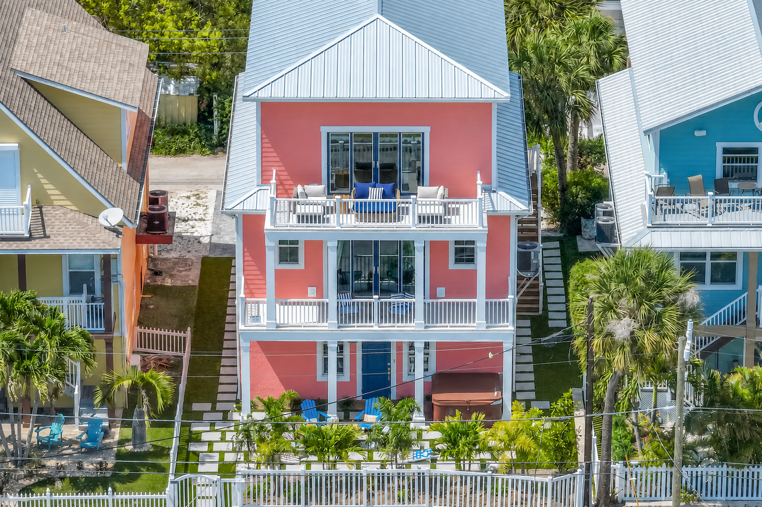 Front facade of the pink three-story coastal home