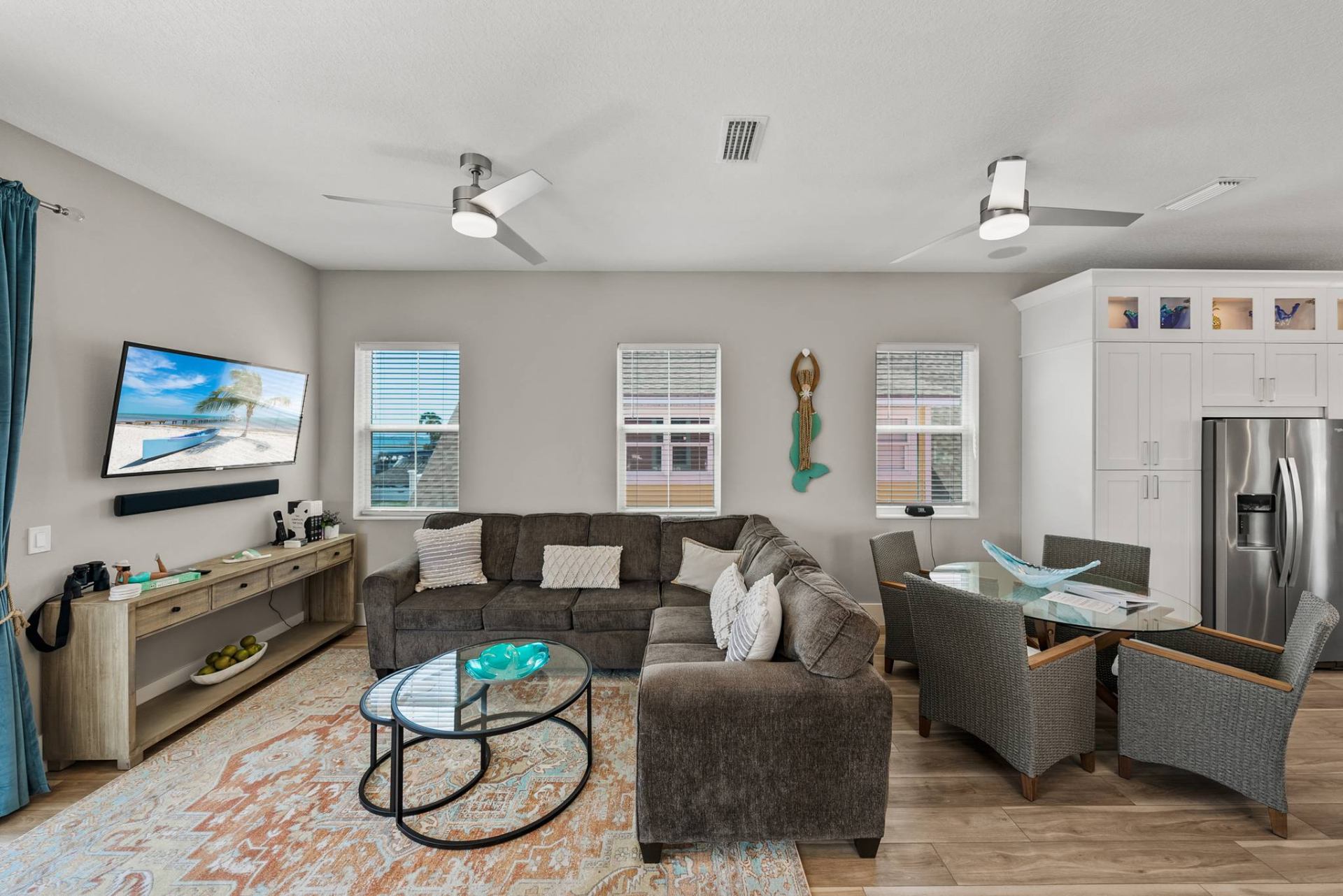 Open living room with sectional, TV, and dining