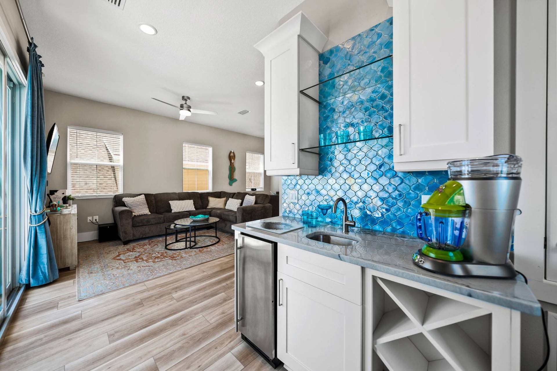 Wet bar with blue mosaic tile backsplash
