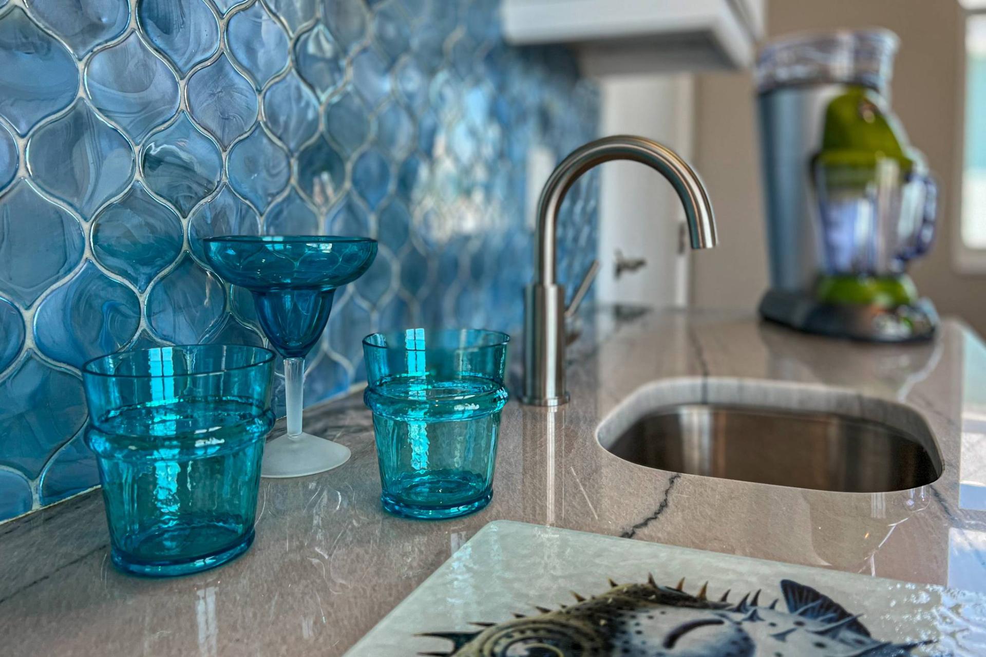 Close-up of blue glassware on the bar