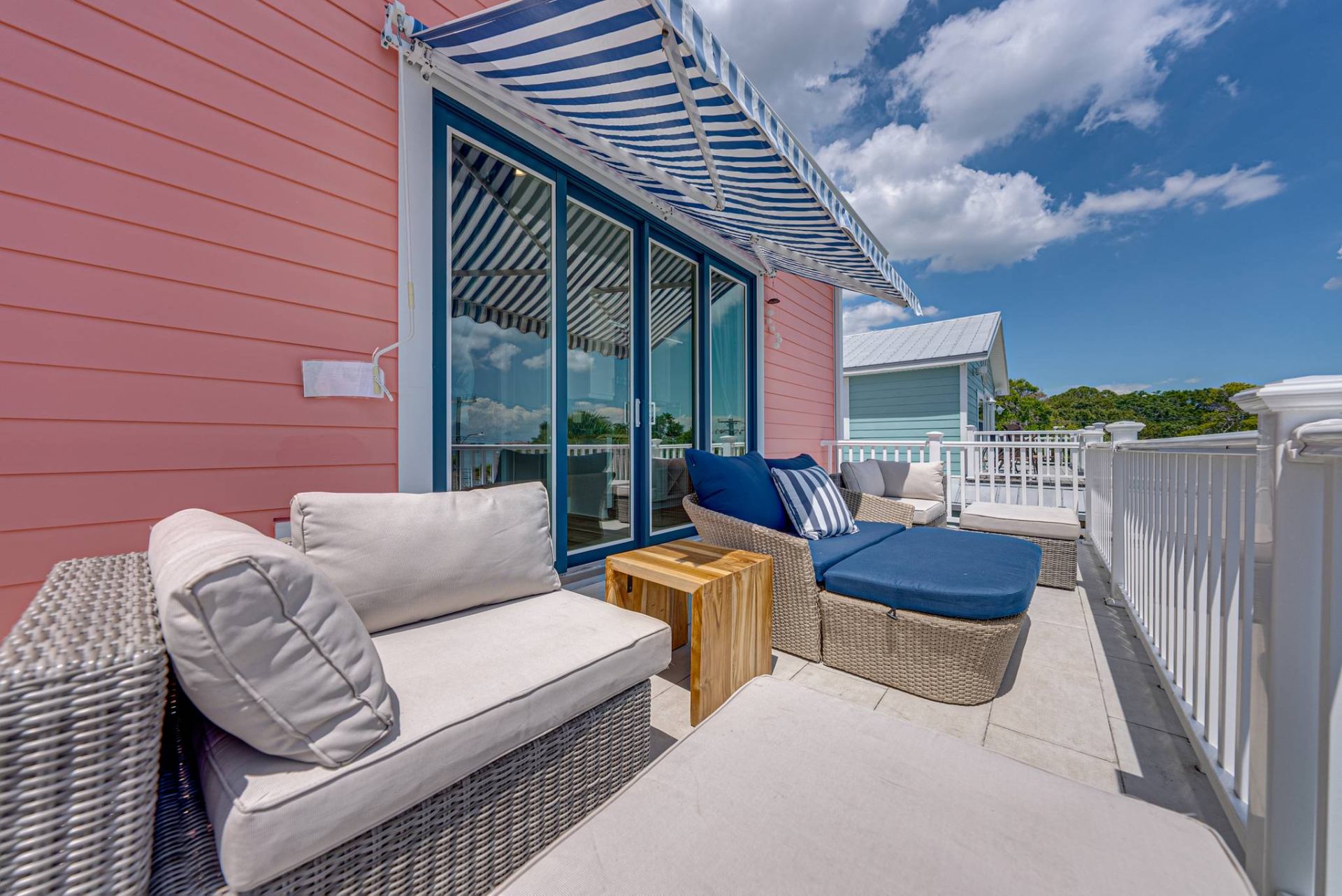 Balcony daybed under blue striped awning