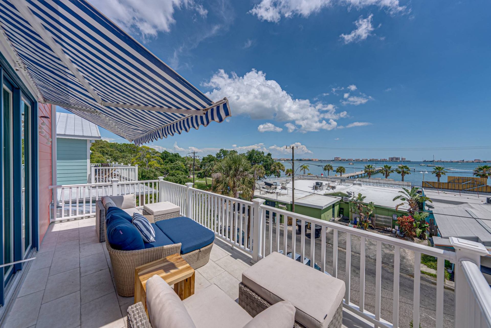 Wide balcony view of palms and bay