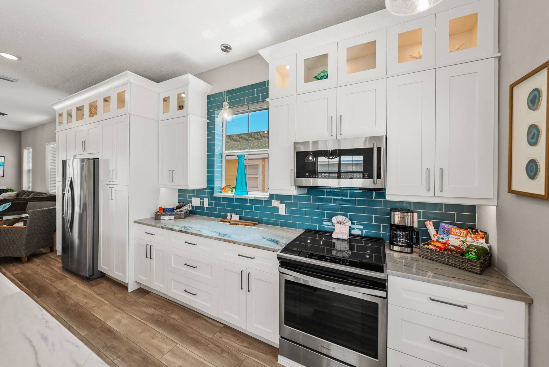 White kitchen with teal subway tile backsplash