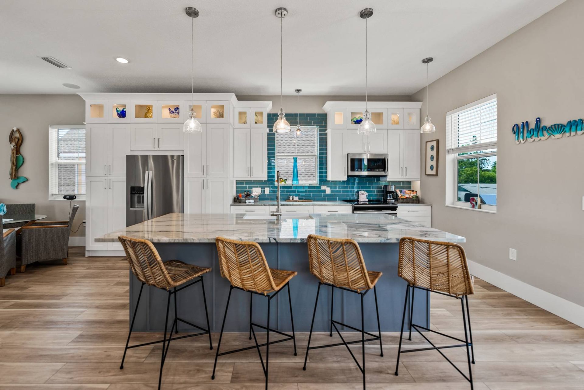 Designer kitchen with marble island and rattan stools