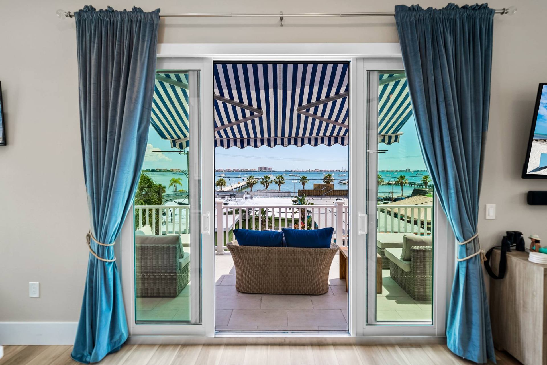 Bay view through French doors with curtains