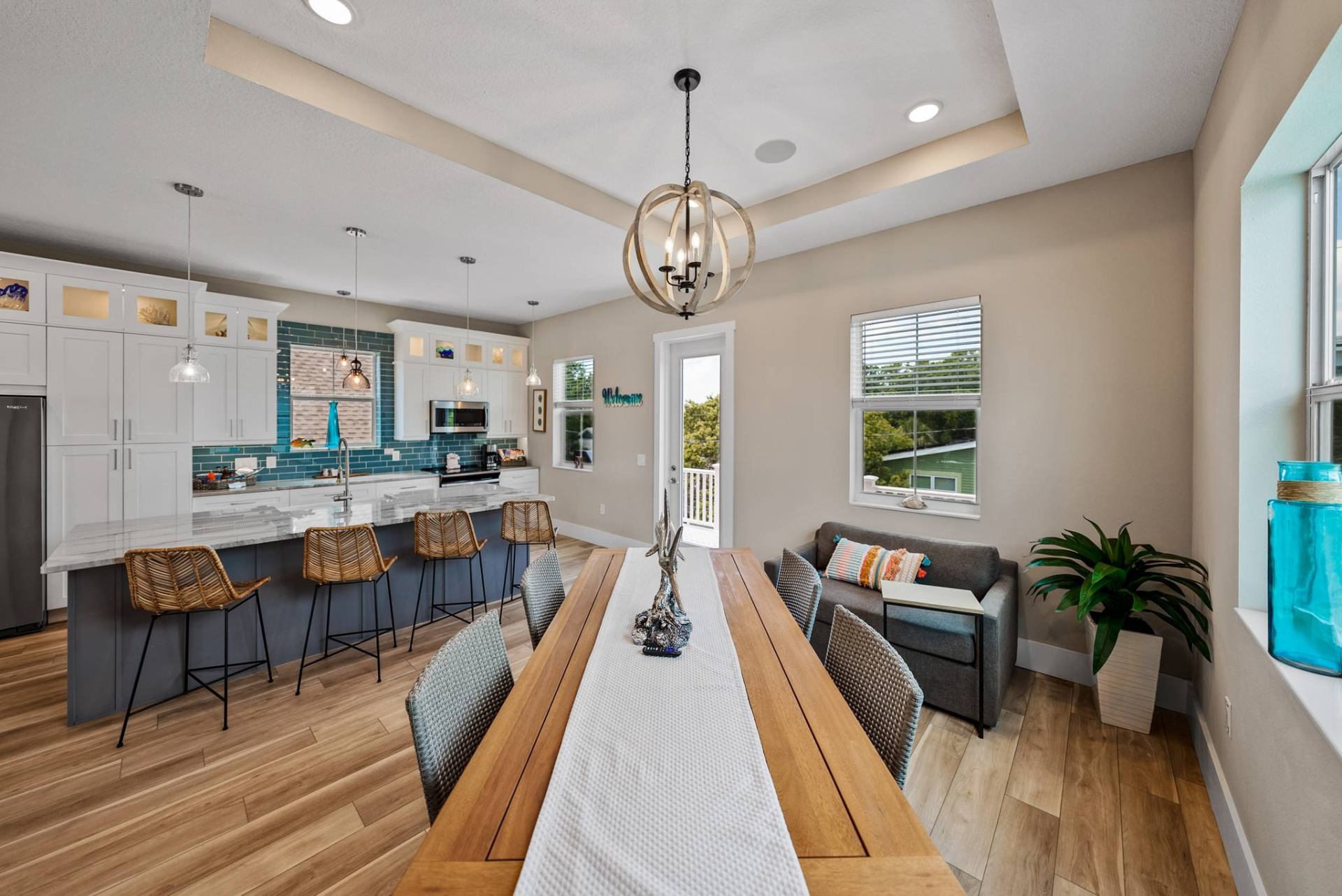 Long dining table with bar seating and welcome sign