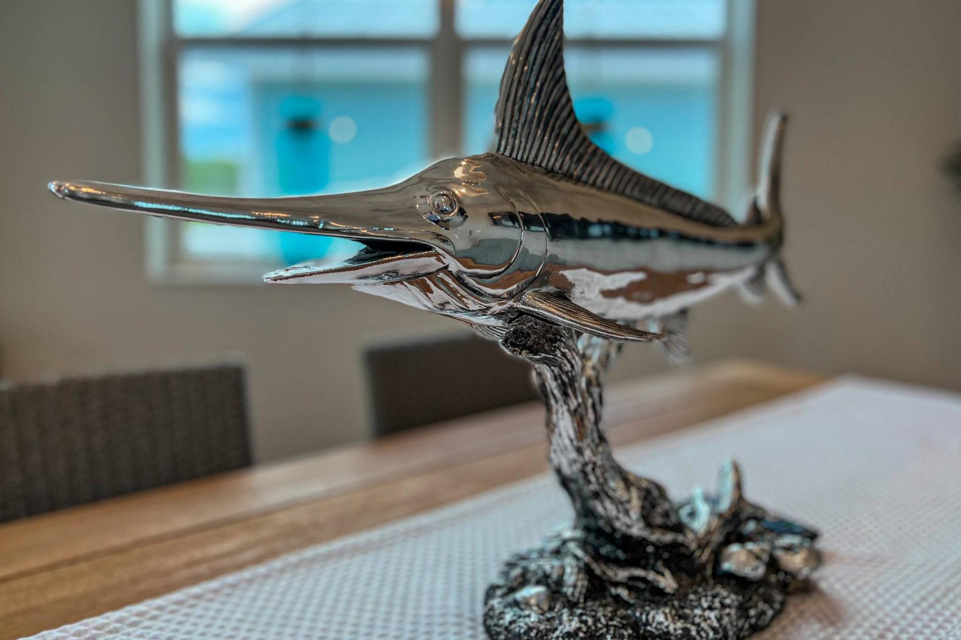 Polished marlin sculpture centerpiece on dining table