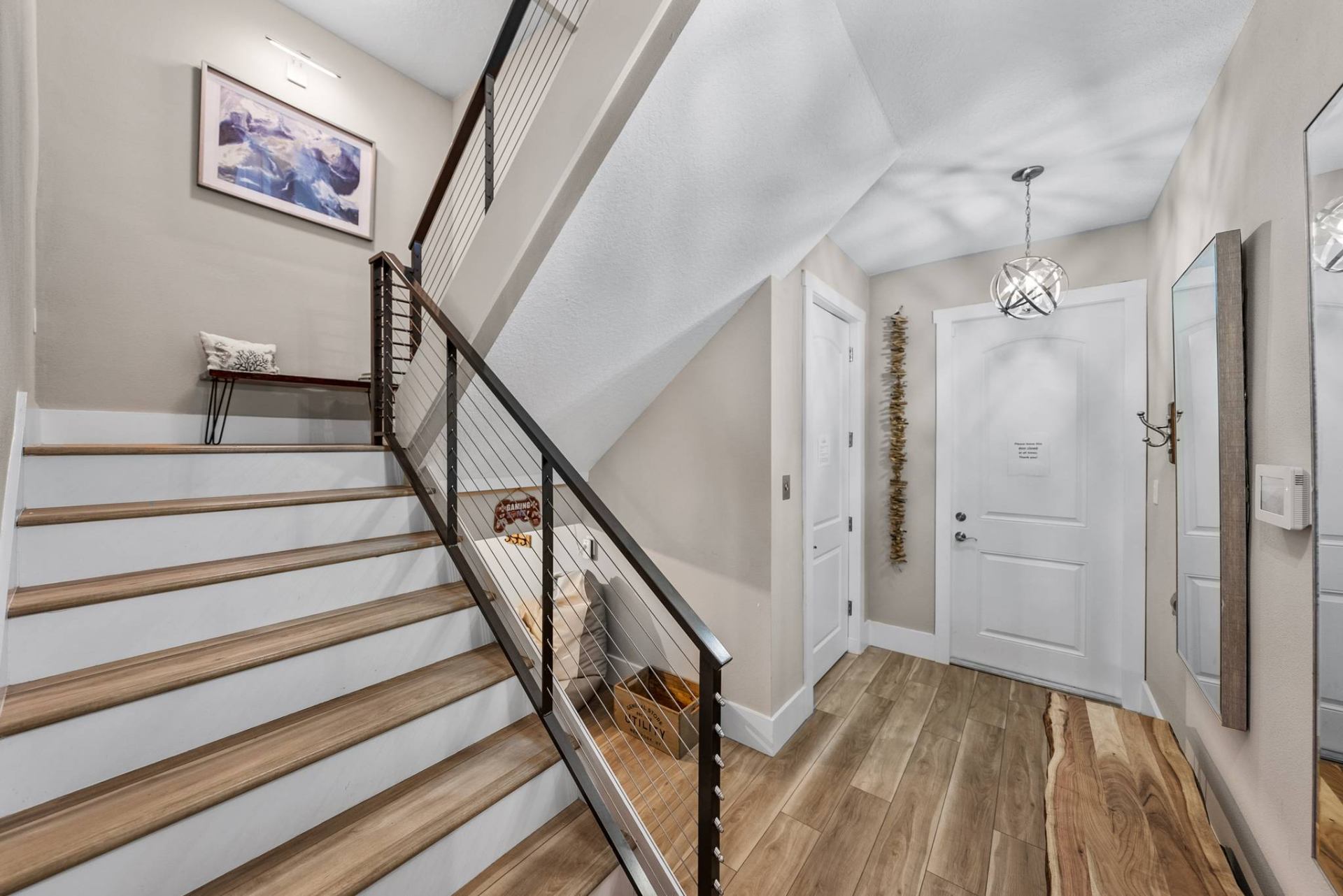 Entryway with staircase and modern cable railing