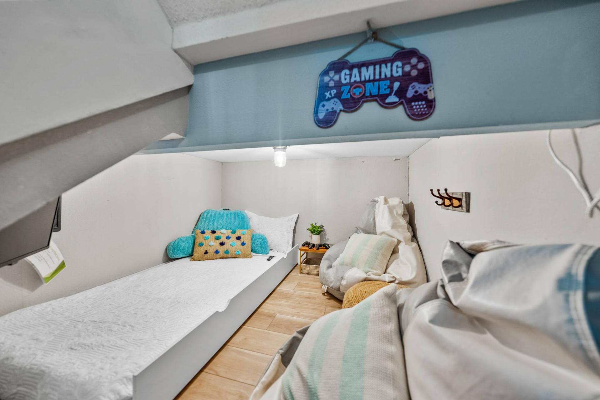 Under-stair gaming zone with twin bed and bean bags