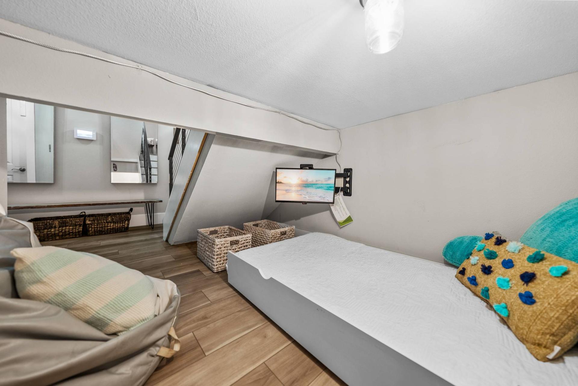 Cozy bonus nook with twin bed and wall-mounted TV