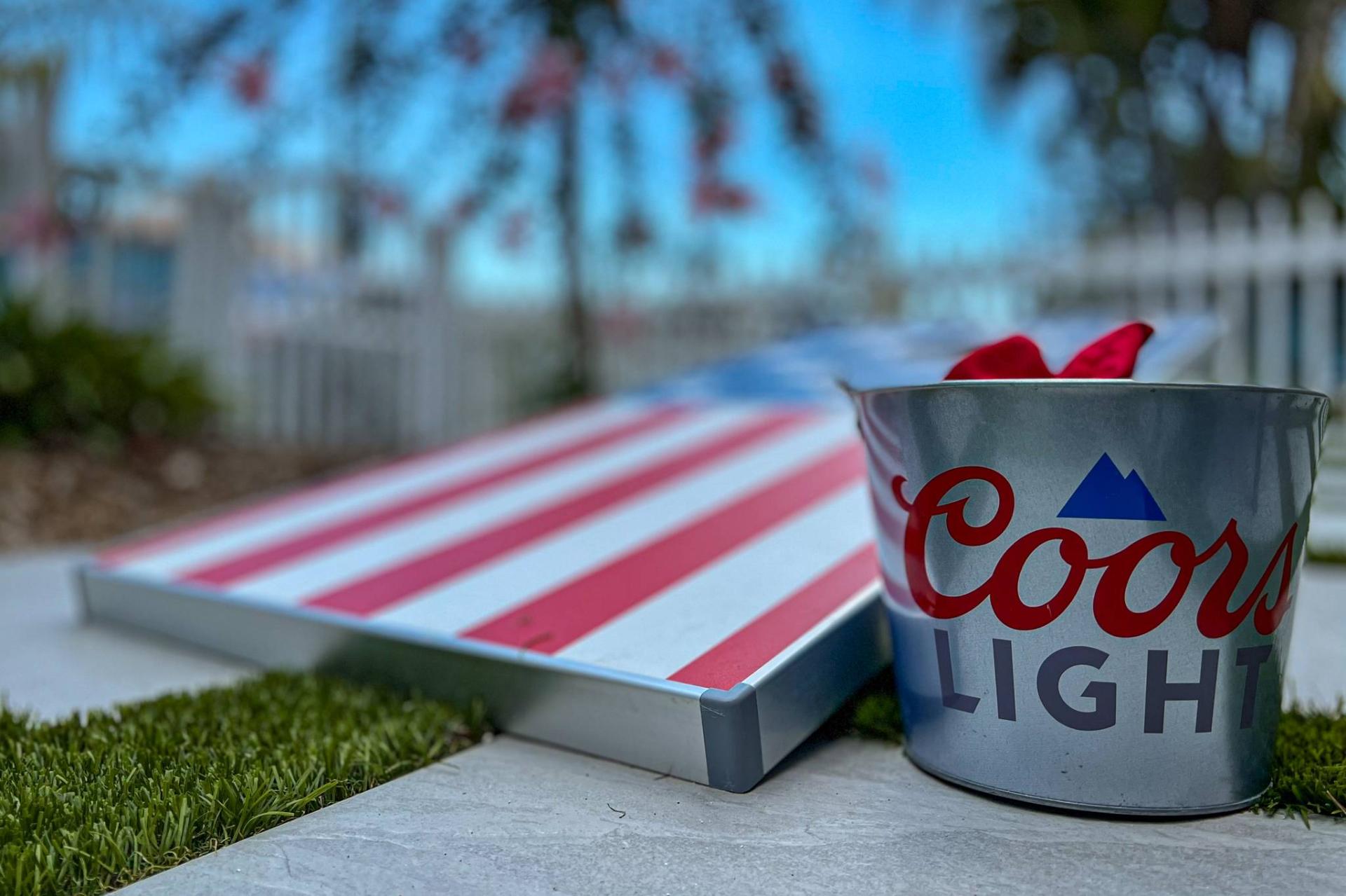 Outdoor cornhole and drinks setup