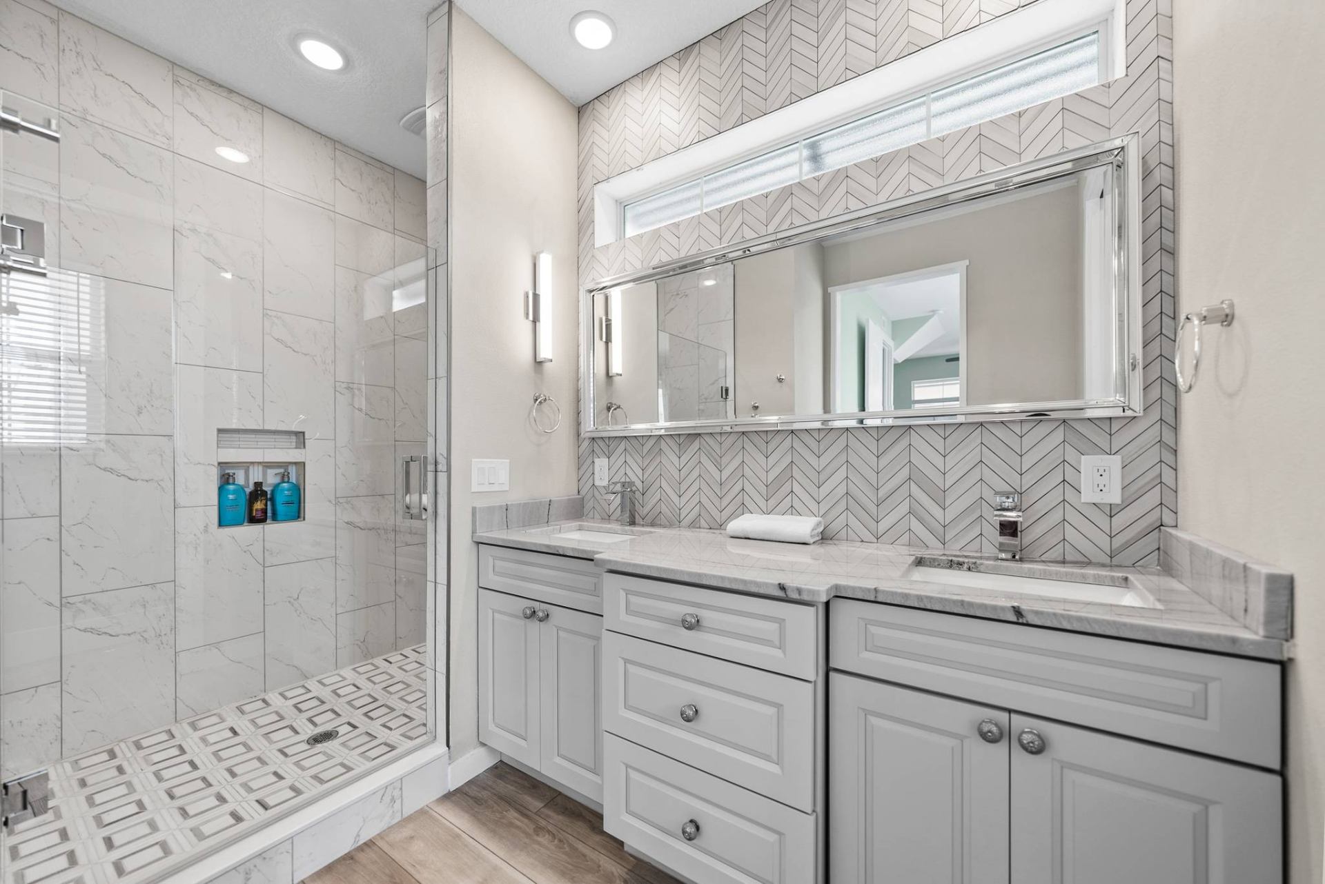 Primary bath with double vanity and chevron tile