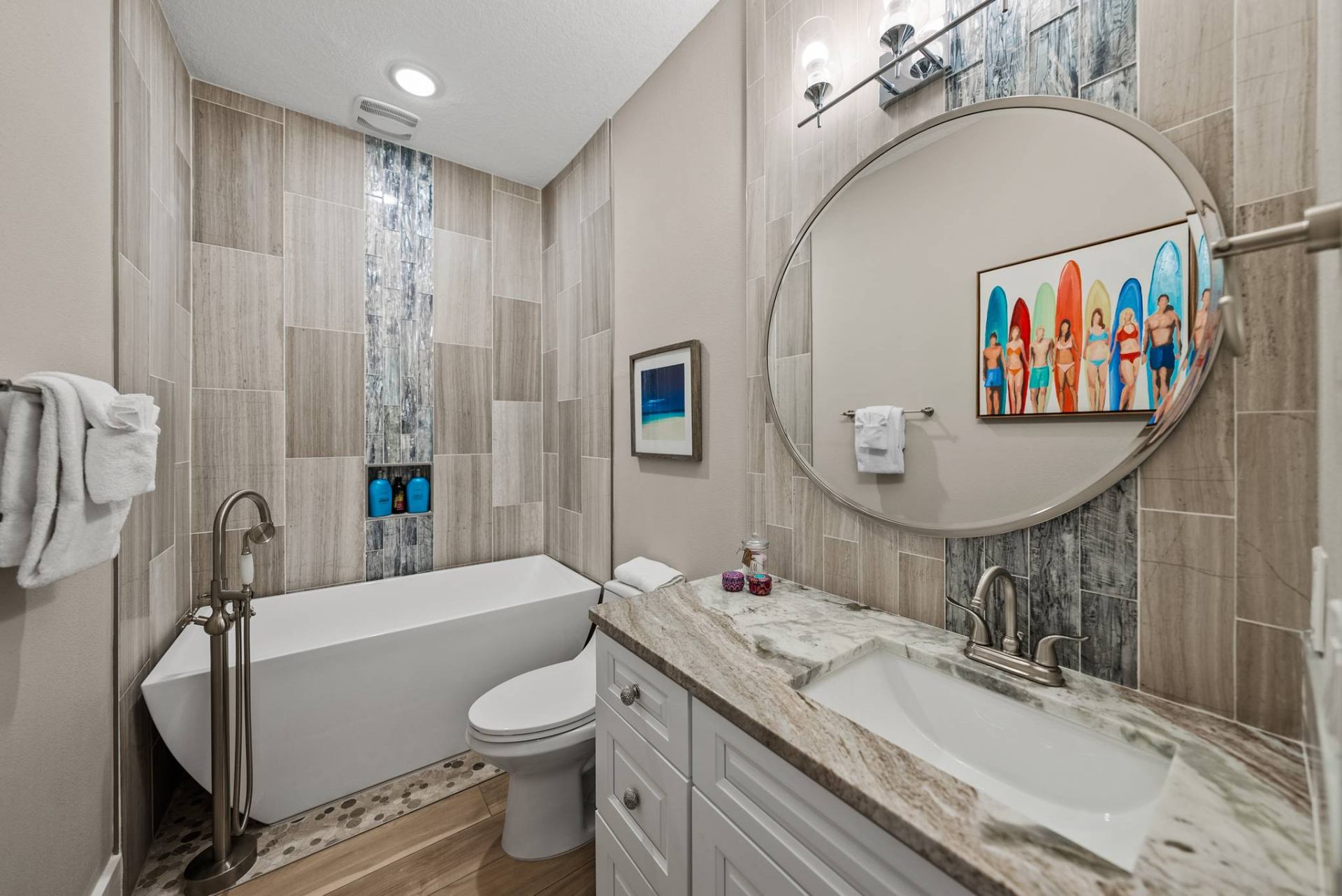 Spa bath with freestanding soaking tub and surfboard art