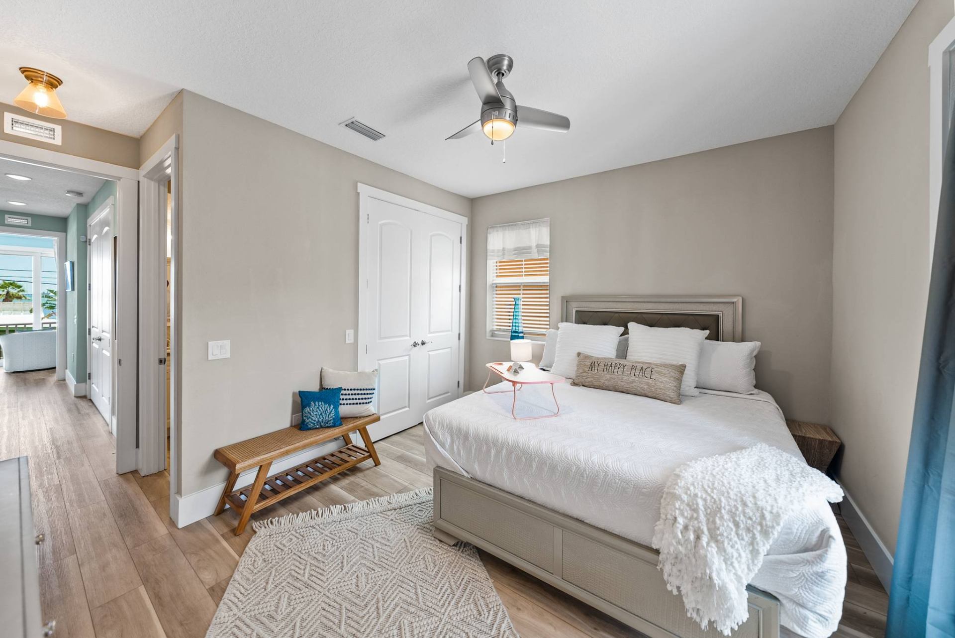 Primary bedroom with king bed and coastal decor
